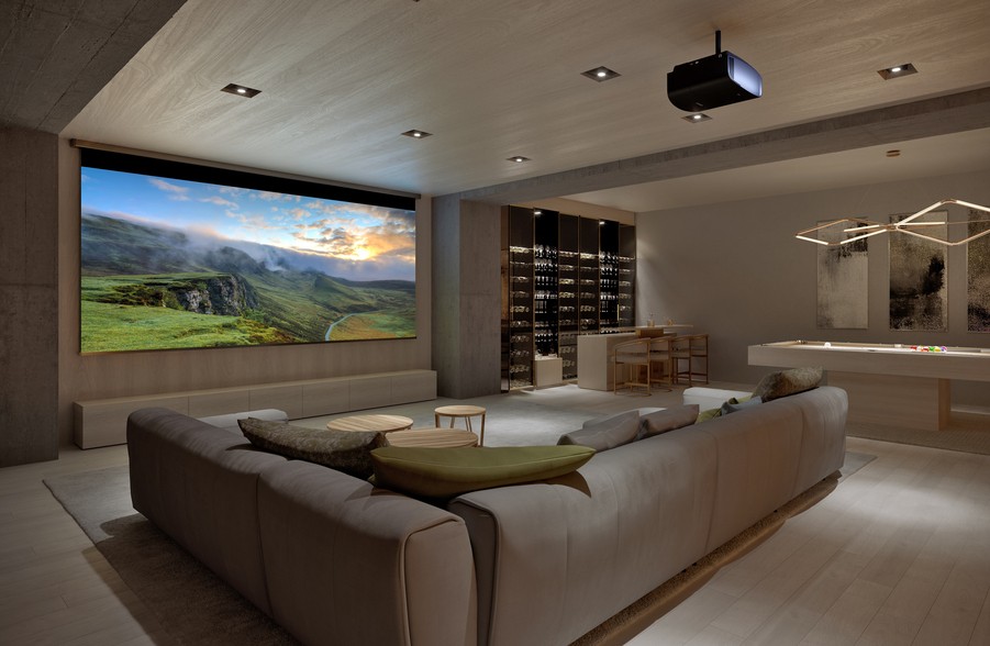 A modern media room with a Sony projector and screen. 